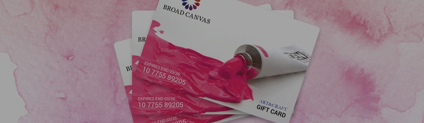 Pink and white gift cards displayed out on a table