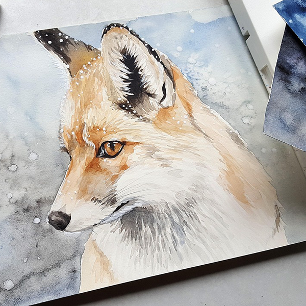 A finished watercolour depicting a fox in the snow