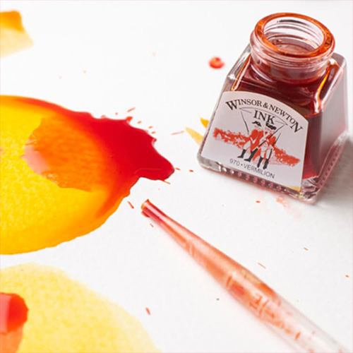 open bottle of yellow ink, splashed around on some