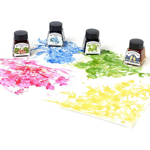 four bottles of bright coloured inks sat on ink-sp